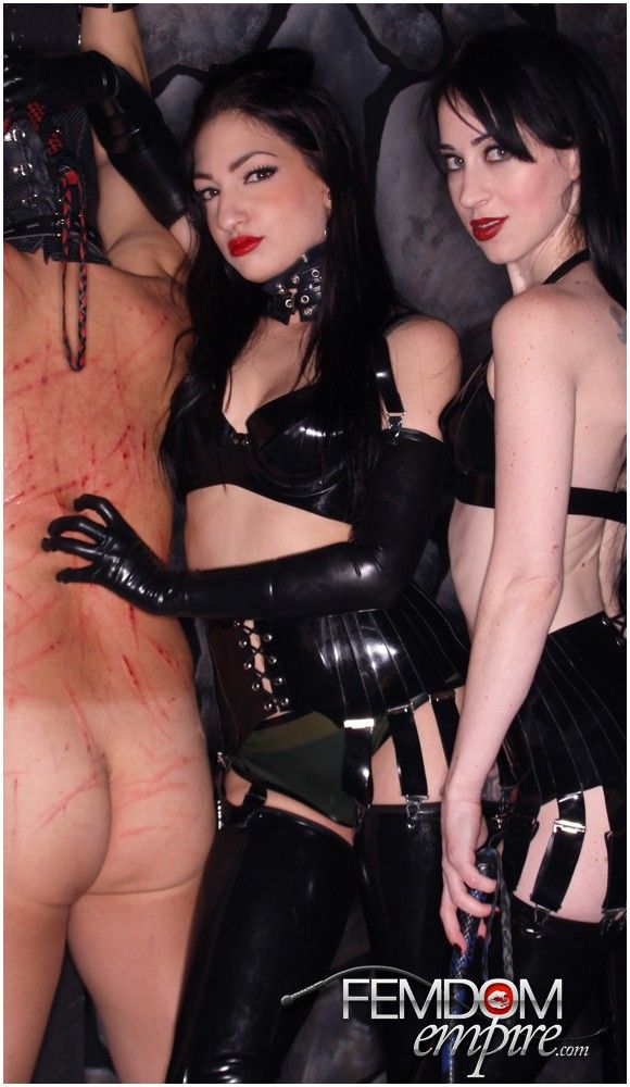 Beautiful Mistresses in latex whip a slave