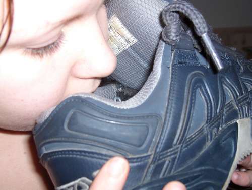 Girl sniffing Buffalo skate shoe; Foot 